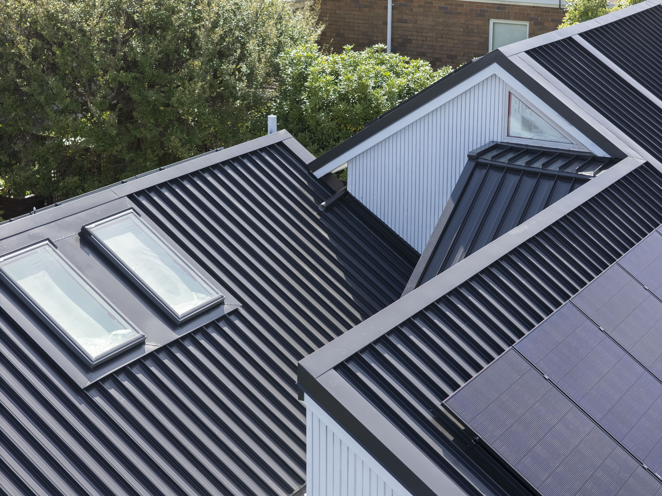close up of angled metal roofing with sky light and flashings in a christchurch home