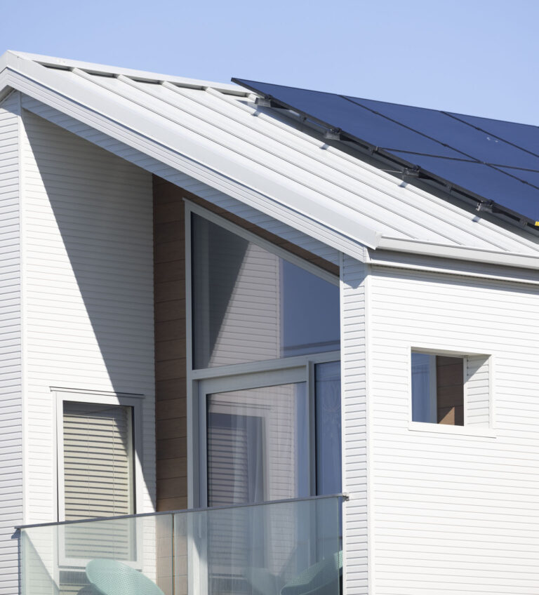 a modern, beach front townhouse with metal roofing, flashings and solar panels based in Christchurch